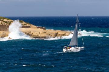 Yacht in rough seas on a sunny day