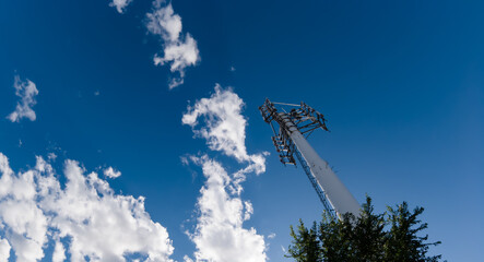 Mobile phone communication radio antenna, 3G, 4G, 5G, 6G. Antenna over cloudy blue sky at summer....