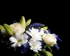 Obraz na płótnie Canvas Funeral Bouquet purple White flowers, Sympathy and Condolence Concept on blackbackground with copy space.