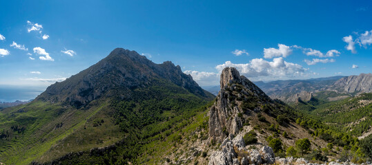 mountains and a beautiful sky from ponoig mountain and puig campana mountain in the background near...