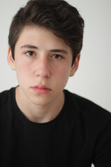 Fototapeta premium portrait of boy with dark hair looking at camera