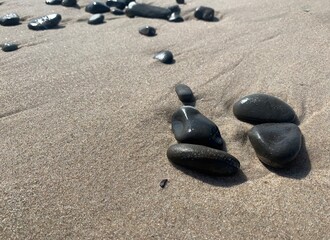 Fototapeta na wymiar Beautiful sea pebbles on the sandy beach, natural background