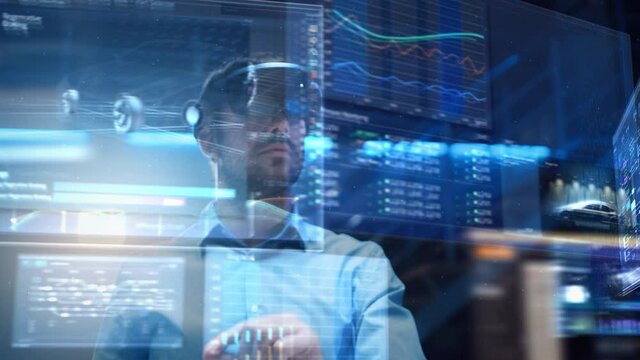 Young Adult Male Engineer Using Futuristic Augmented Reality Software Interface for Managing Work Projects. Specialist in Office Wearing Headset to Look at VFX Animation with Electric Car Concept.