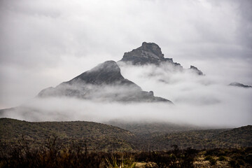 Fototapeta na wymiar Moody Fog Wisps Through the Chisos Mountains