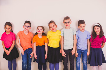 Children in colorful school uniform on white background