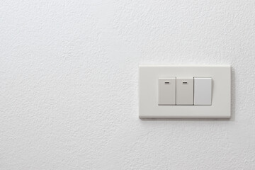Light onoff switch on white wall with space for text.