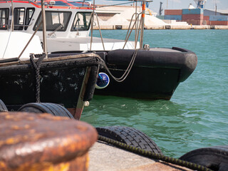 Detail of the Bow of Two Small Moored Boats used as Tugs in Port
