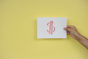 Dollar sign, text message handwritten with felt-tip pen on yellow background