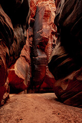 Orange Rock Wall Stained With Desert Varnish Glows At The End Of A Canyon