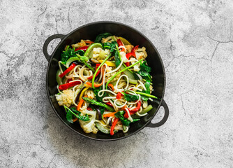 Vegetarian noodles with vegetables - cauliflower, zucchini, pepper, spinach, eggplant, carrot wok...
