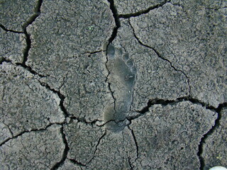 human footprint on cracked ground