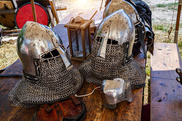 Knight's helmet made of steel on a wooden table.