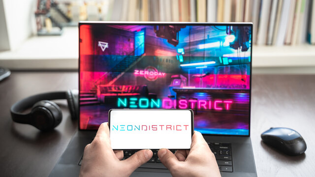 Russia Moscow 30.05.2021.Logo,screenshot of blockchain nft ethereum cryptocurrency kiber punk game Neon District in laptop, mobile phone. Man playing, collecting cards. Earning tokens,digital money