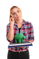Female student holding green piggy bank and thinking