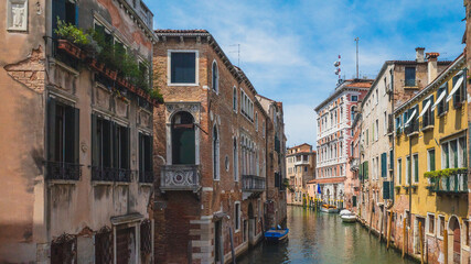 Fototapeta na wymiar Canal between venetian houses in Venice, Italy