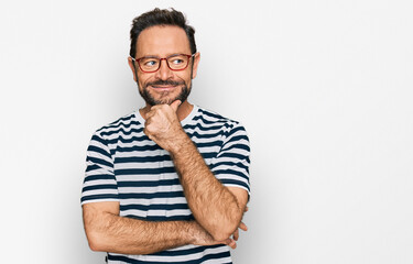 Middle age man wearing casual clothes and glasses with hand on chin thinking about question,...