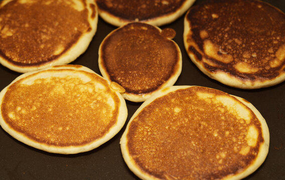 Making Thick Pancakes On Dark Griddle Surface