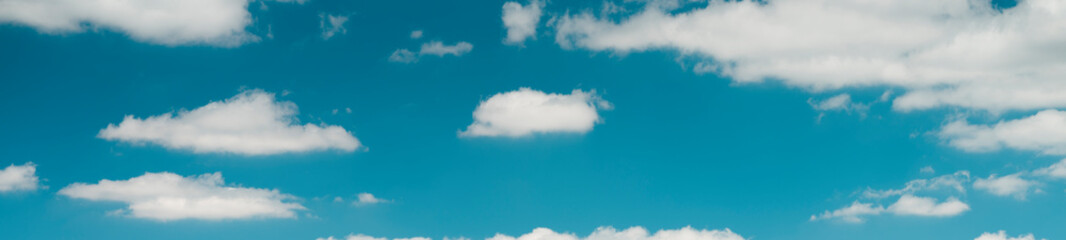 Fototapeta na wymiar White clouds in the turquoise sky