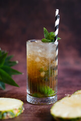 Cold pineapple cocktail with crushed ice and mint.