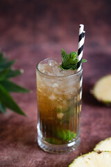 Cold pineapple cocktail with crushed ice and mint.