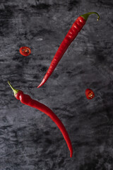 red hot chili pepper levitating on a dark background