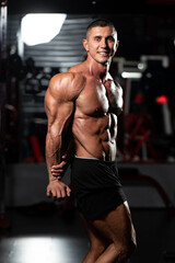 Fototapeta na wymiar Bodybuilder Performing Triceps Pose