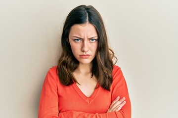 Obraz premium Young brunette woman wearing casual clothes skeptic and nervous, disapproving expression on face with crossed arms. negative person.