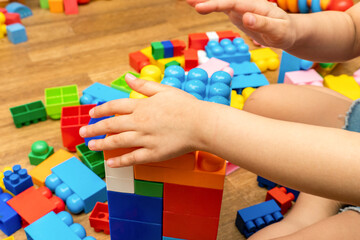 kid, child hands, while playing with educational toy blocks constructor