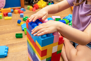kid, child hands, while playing with educational toy blocks constructor