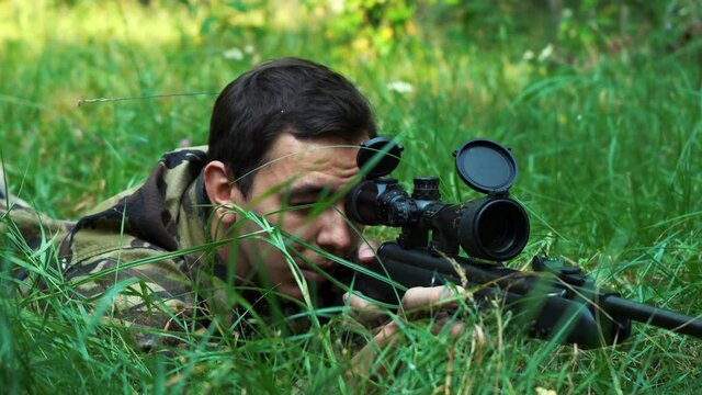 sniper aim while lying in the bushes