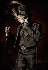 Young man in image of Baron Samedi, the Voodoo deity. Baron Saturday in black suit and top hat with a bottle of alcohol in hand. Day of the Dead (and Halloween) theme