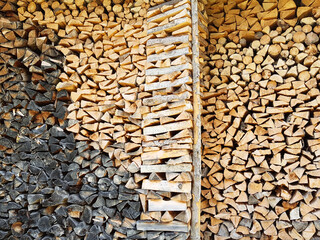 Large stack of wood logs, piled up in an abstract pattern, at a farm in Vorarlberg, Austria..
