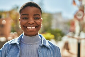 Young african american woman smiling happy standing at the city.