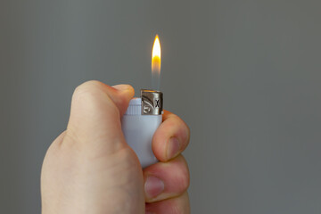 the man lit the lighter with his left hand