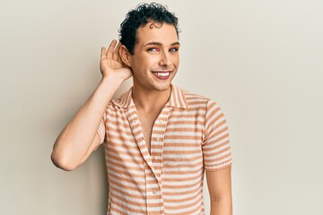 Handsome man wearing make up wearing casual t shirt smiling with hand over ear listening an hearing...