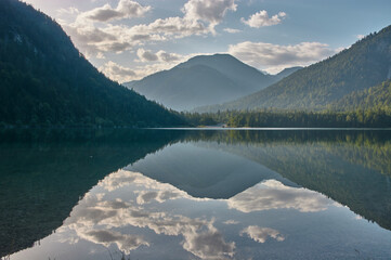 Mirroring mountain lake during sunrise in the Austrian alps.