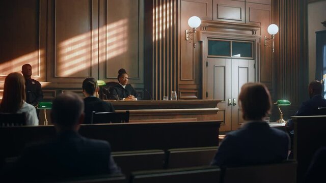 Court of Justice Trial: Impartial Judge Sitting Down, Public Sits Down on Benches After Her. Supreme Federal Court African American Female Judge Starts Civil Case Hearing with Striking a Gavel.