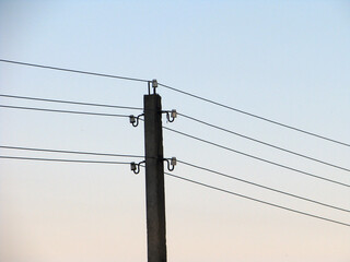 pole with electric wires against the background of the evening sky