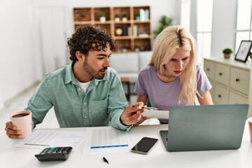 Obraz premium Young couple controlling family economy at home.