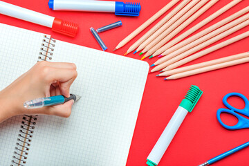 Back to school. The child writes in a notebook with a fountain pen The concept of the beginning of...