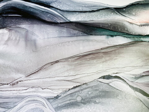 Abstract grey art with purple, green and silver paint — pearly background with beautiful smudges and plisse made with alcohol ink. Grey fluid texture resembles marble, smoke, watercolor or aquarelle. © Luvricon