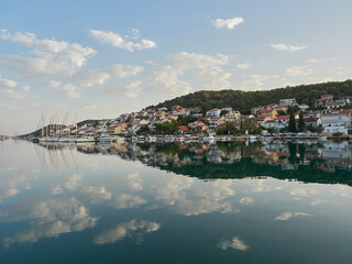 Fototapeta na wymiar Tisno, Croatia - City landscape in the morning overlooking the marina with boats. Murter Island.