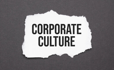 corporate culture sign on the torn paper on the black background