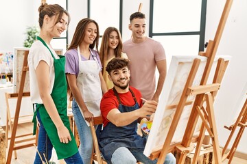 Group of people smiling happy and looking draw of partner at art studio.