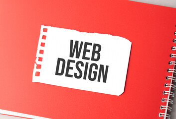 The word web design on torn paper on red notepad,.