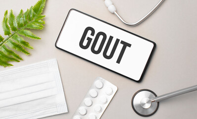 Gout word on smartphone,stethoscope and green plant