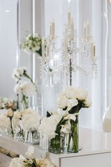 Romantic Wedding Table Top Layout Decor with large lush floral bouquets including white roses, ranunculus, persian buttercups, white orchids and candles