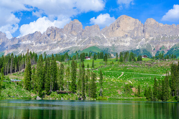 Paradise scenery at Karersee (Lago di Carezza, Carezza lake) in Dolomites of Italy at Mount Latemar, Bolzano province, South tyrol. Blue and crystal water. Travel destination of Europe.