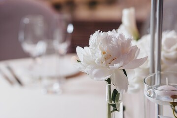 Romantic Wedding Table Top Layout Decor with large lush floral bouquets including white roses, ranunculus, persian buttercups, white orchids and candles