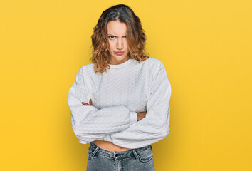 Beautiful young caucasian woman wearing casual winter sweater skeptic and nervous, disapproving expression on face with crossed arms. negative person.